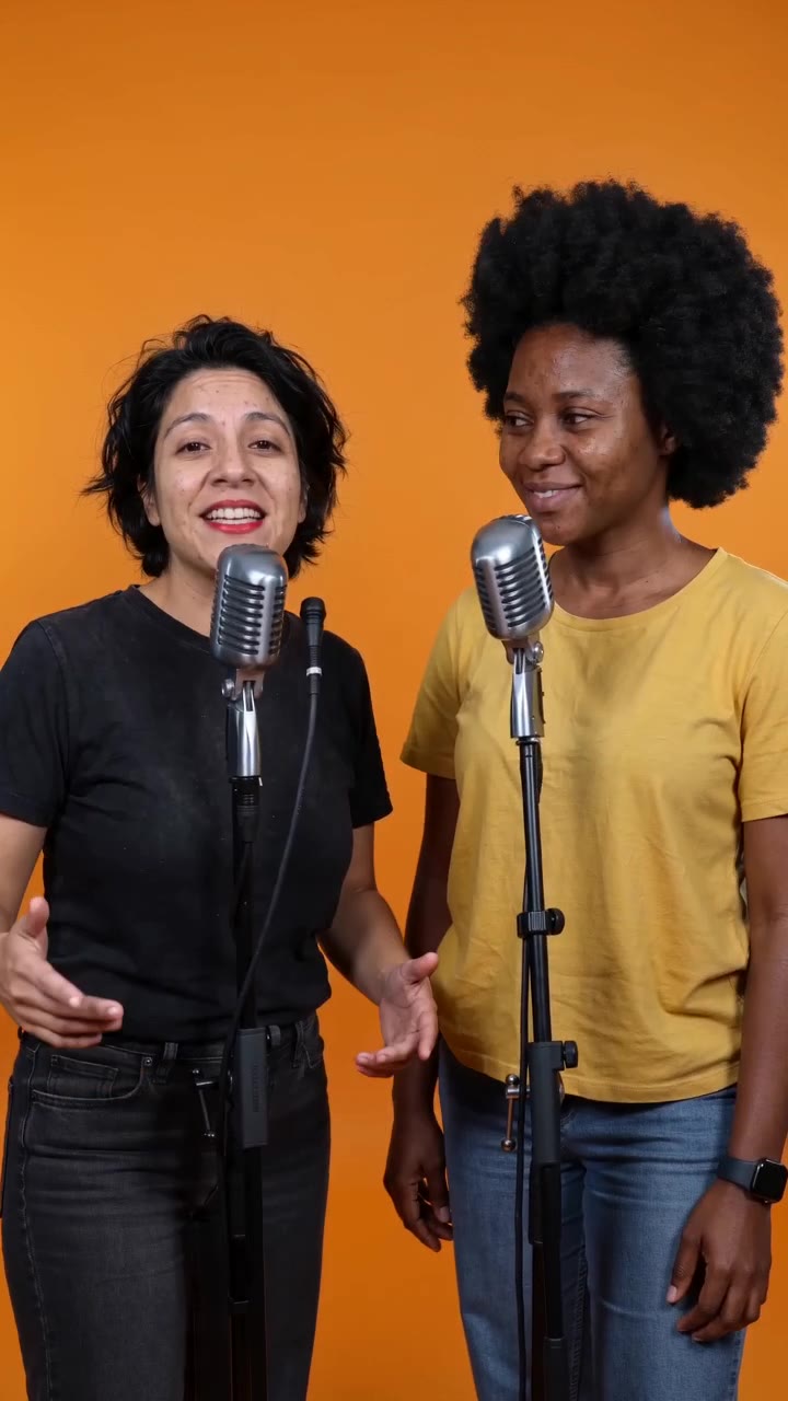 Two friends rapping together at one microphone in the orange Hotel Lobby booth, made with AI Rap Video Generator